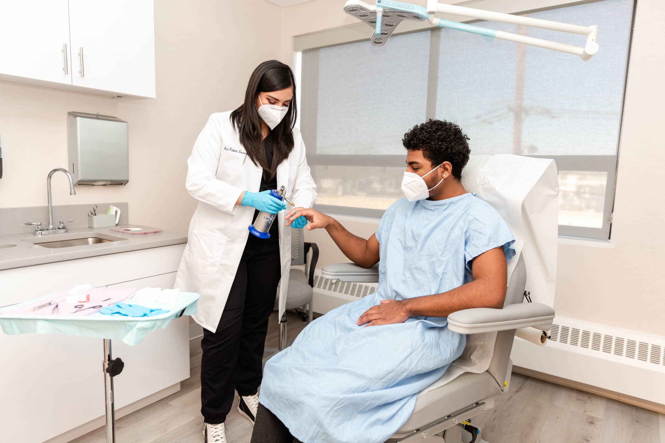 doctor treating a patient with skin growths