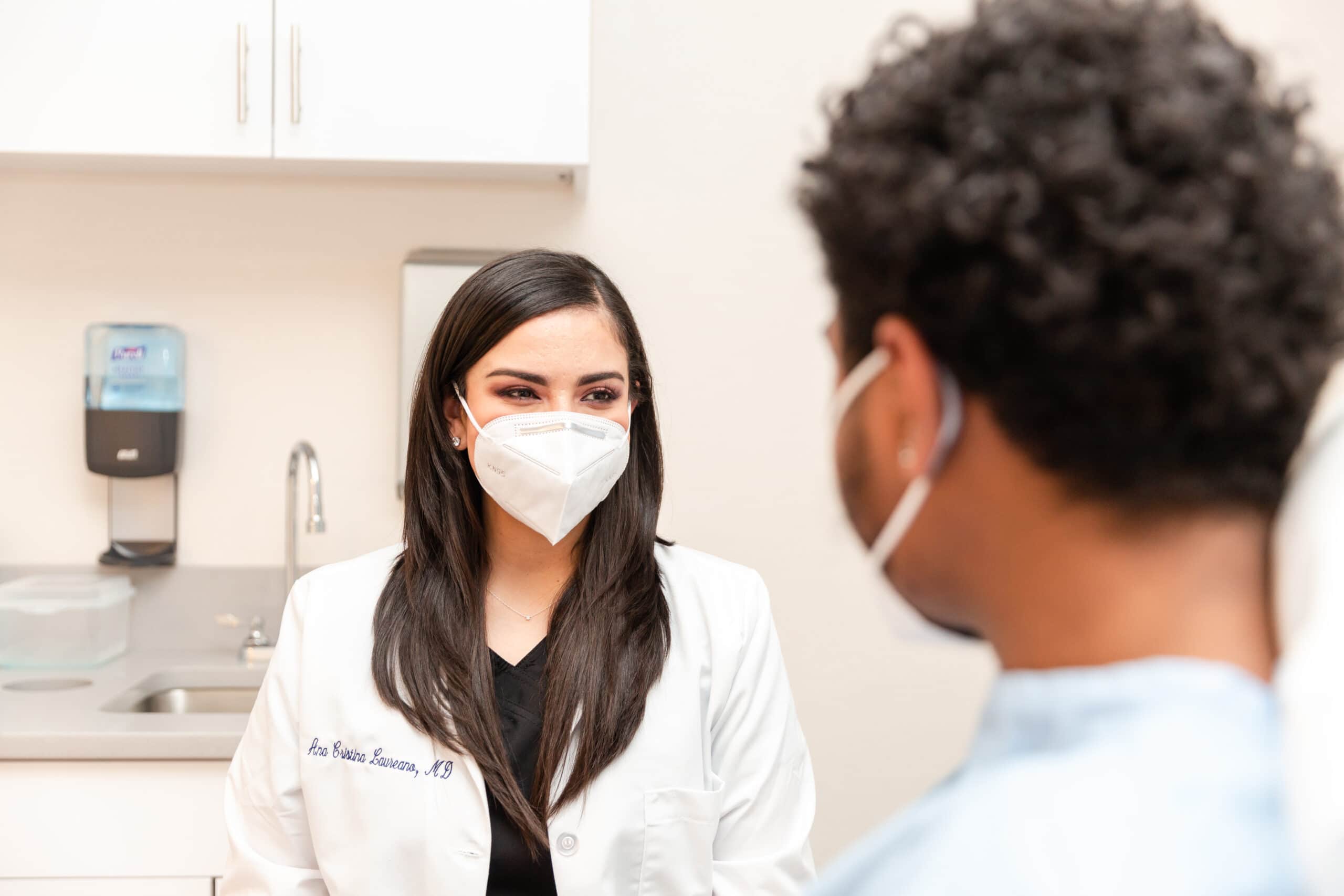 dermatologist examining a patient with dermatitis