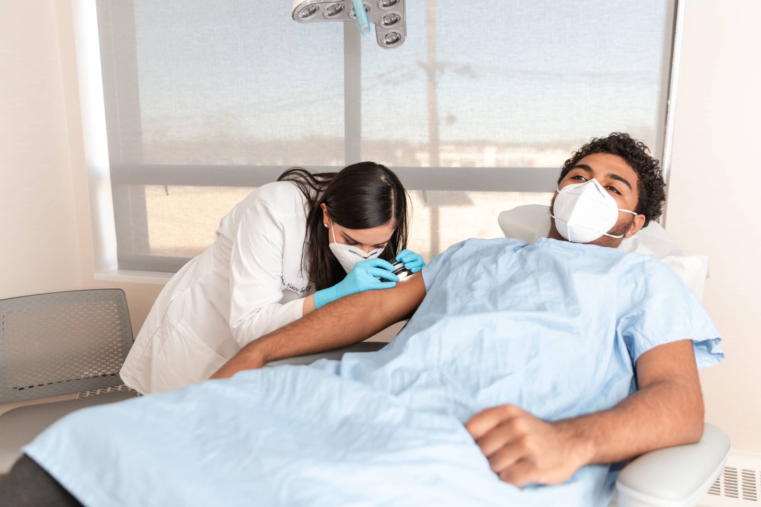 dermatologist from englewood cliffs examining a patient