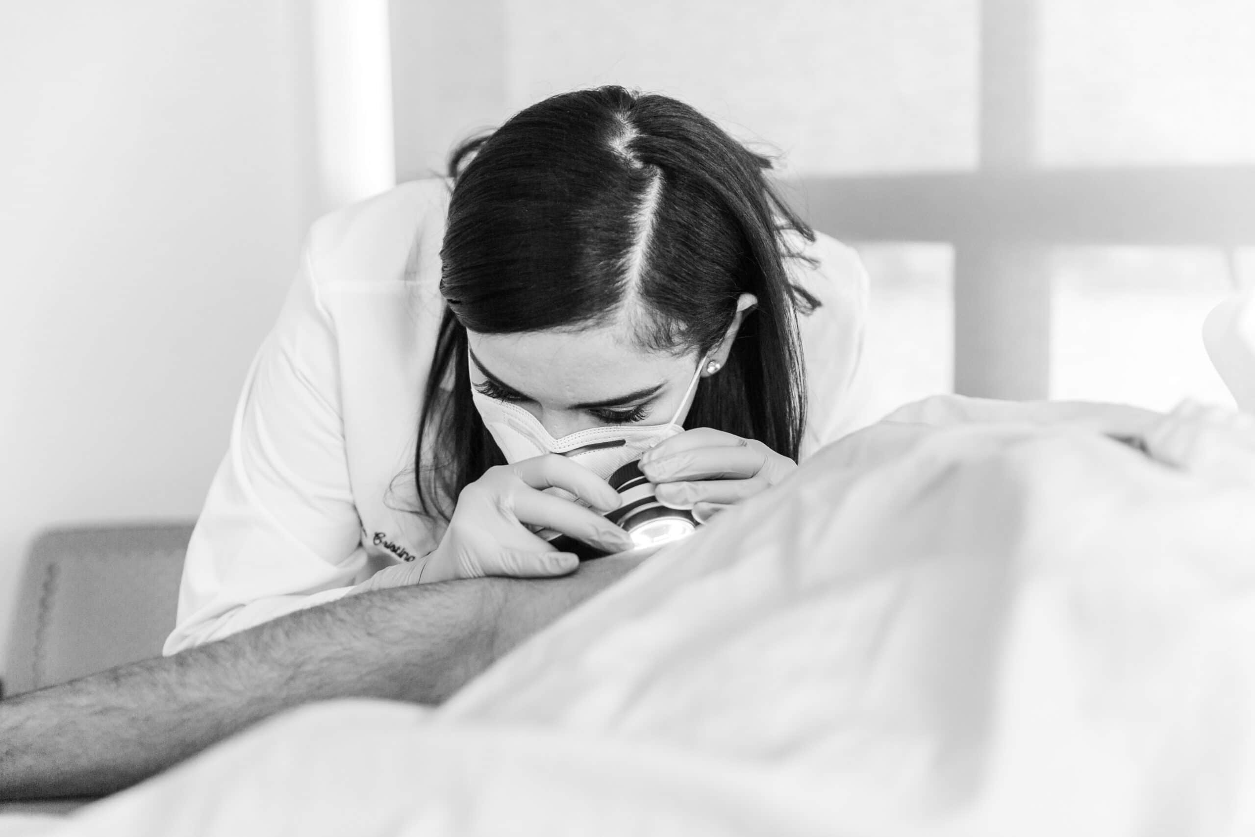 dermatologist checking patients skin for basal cell carcinoma