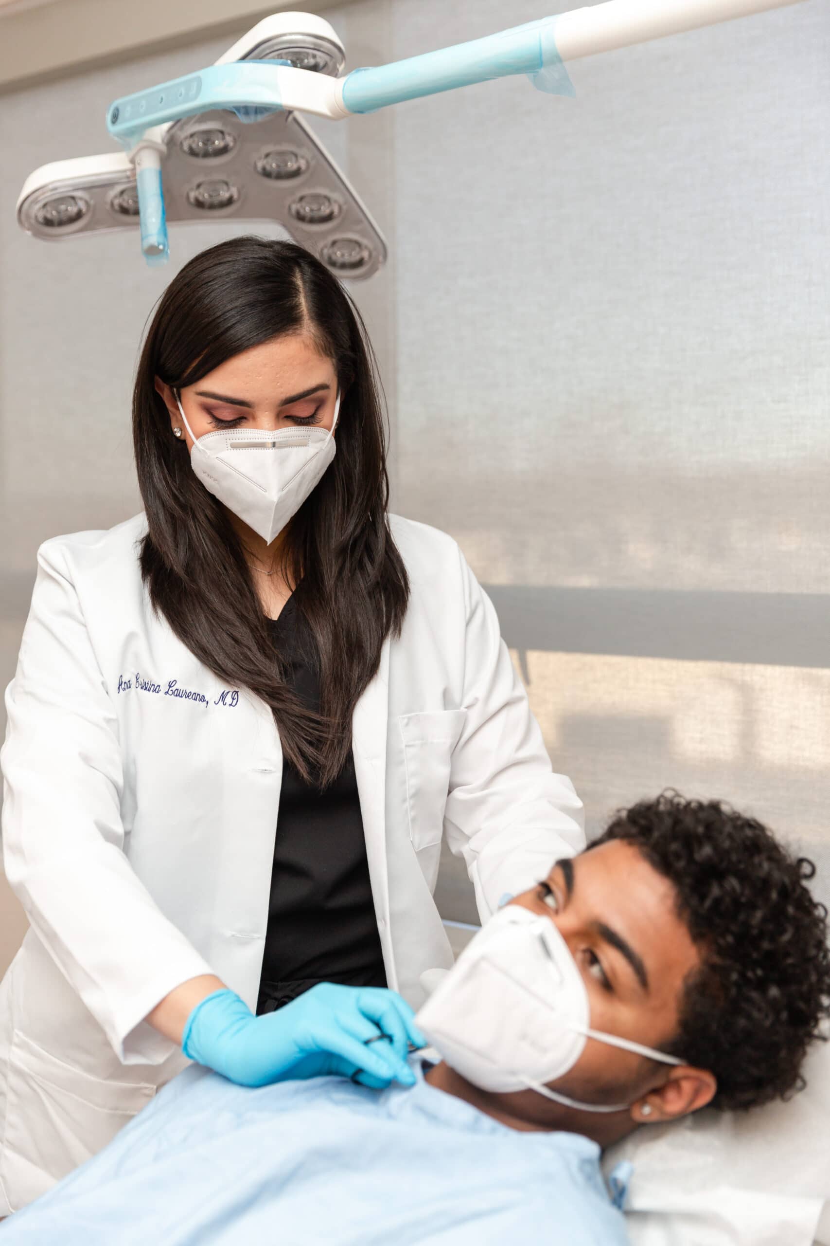 doctor performing a PDT treatment on a male patient