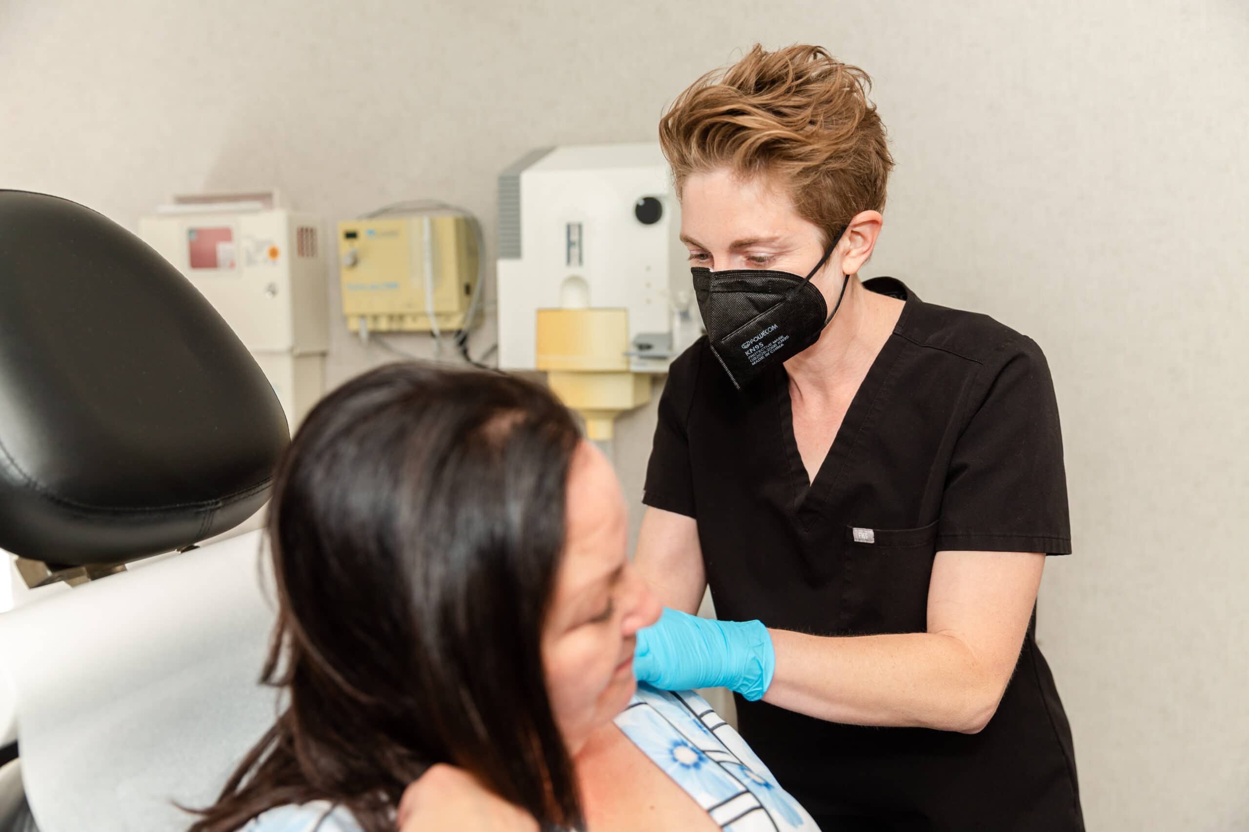 doctor performing an annual skin cancer check on a patient from new jersey