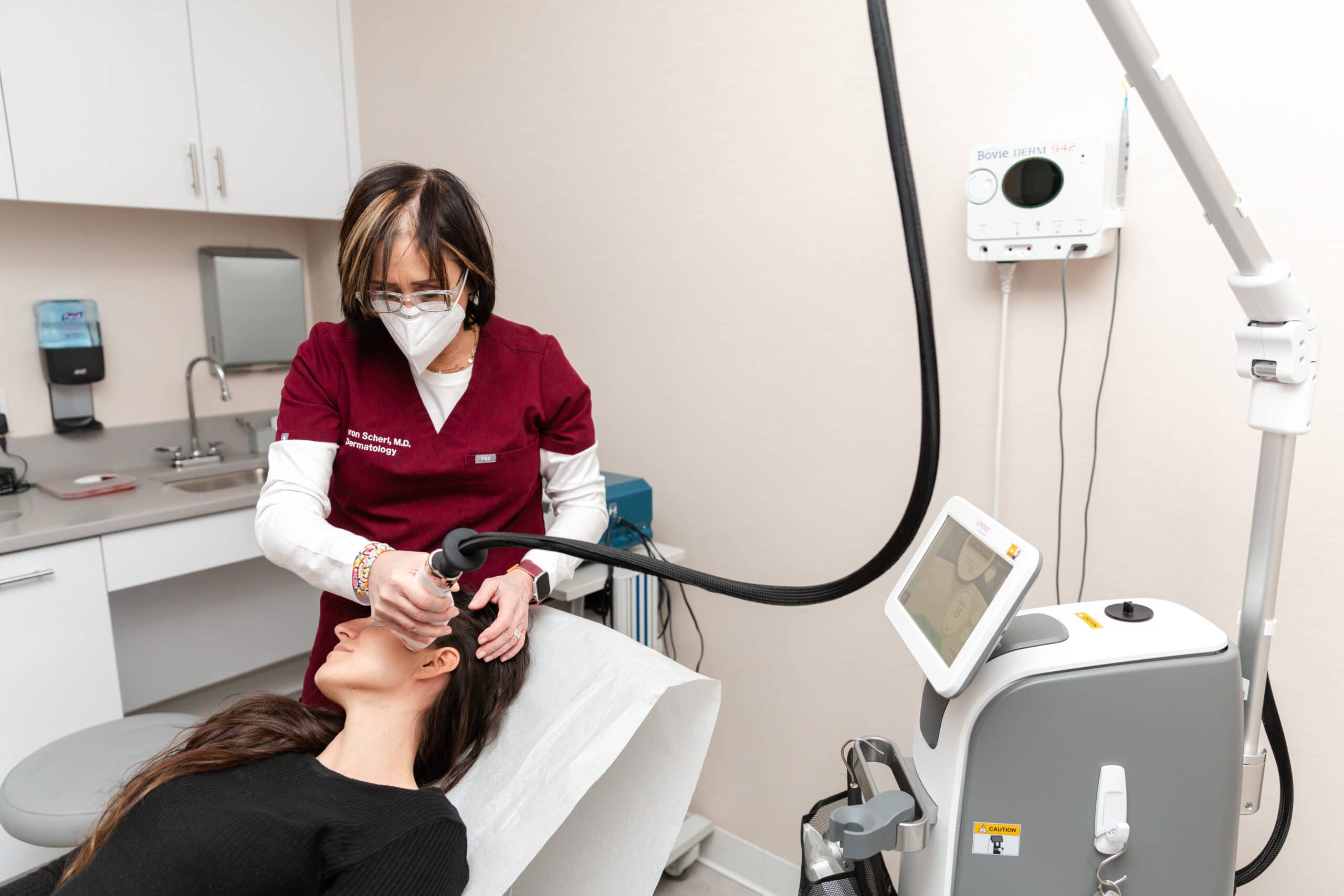 dermatologist treating a patient with a laser skin resurfacing device